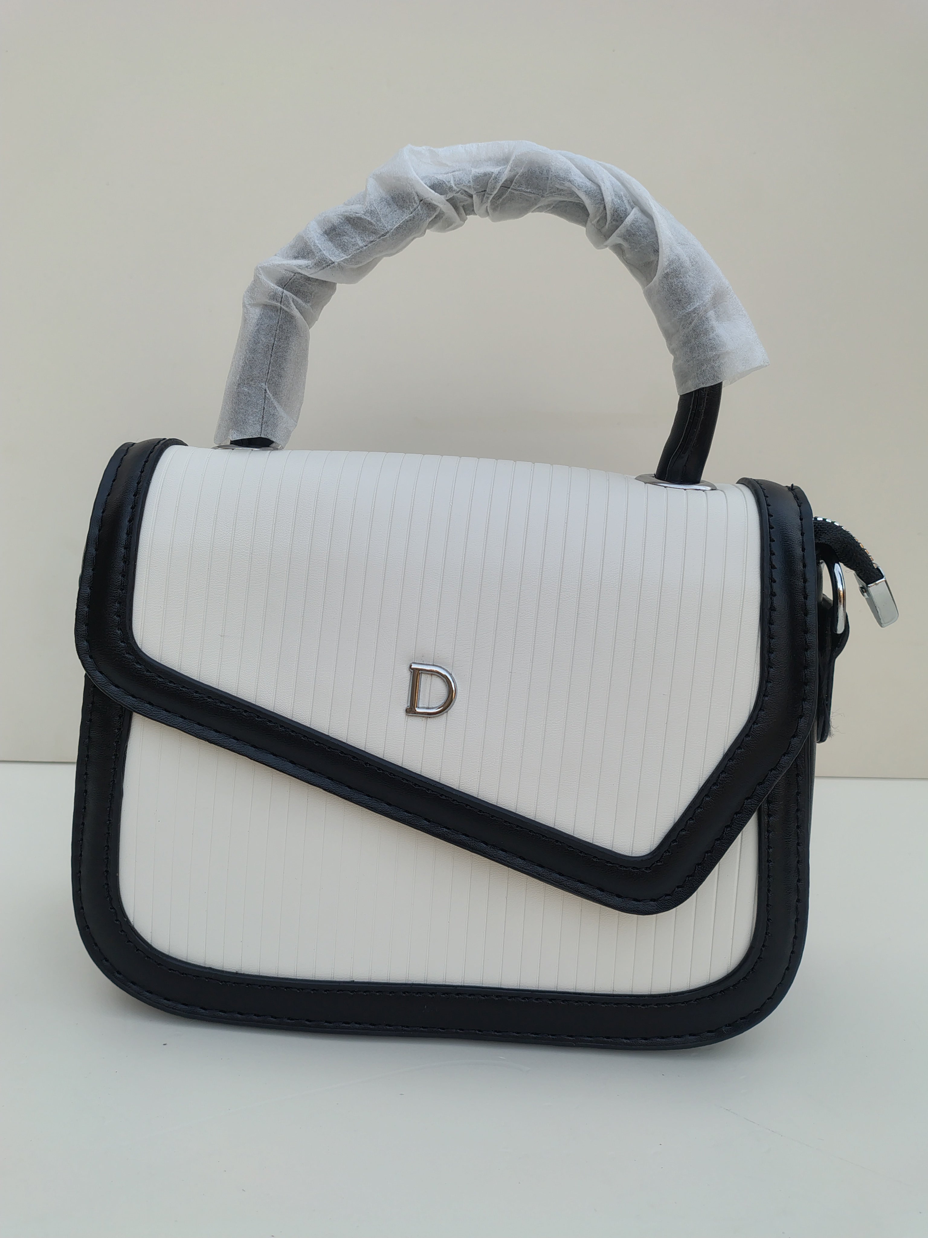 White & Black Structured “D” Handbag – Asymmetric Flap Design
