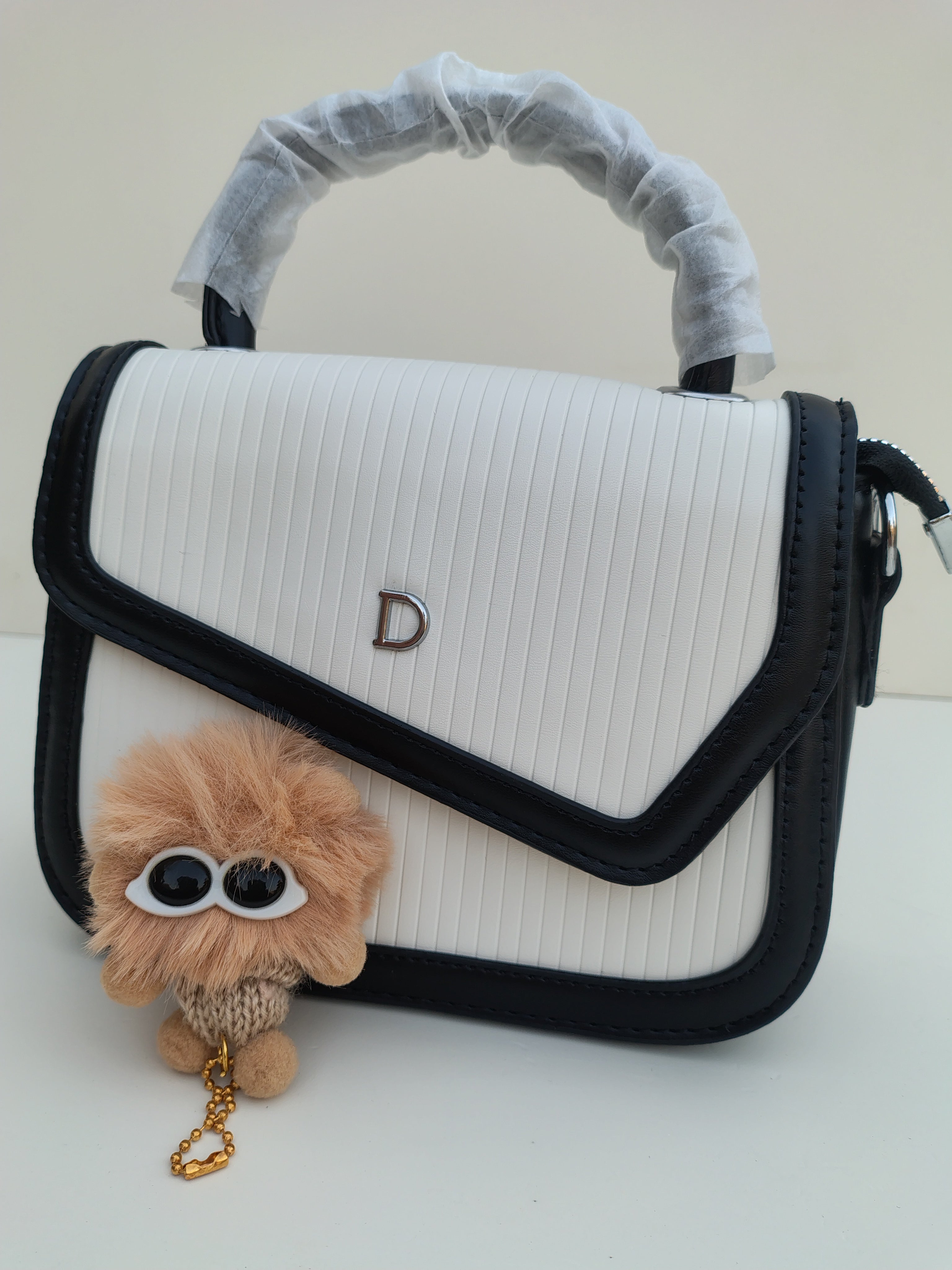 White & Black Structured “D” Handbag – Asymmetric Flap Design