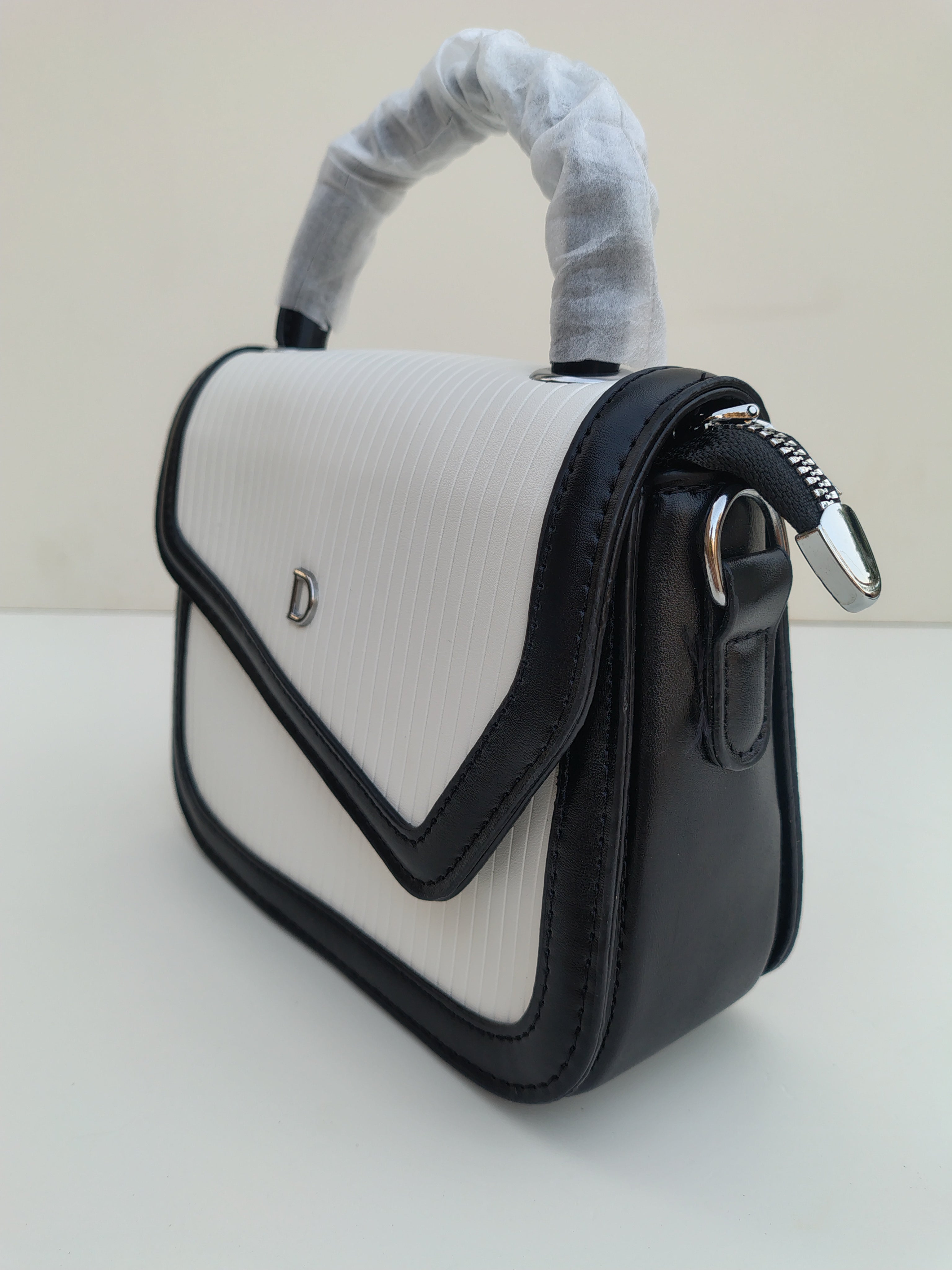 White & Black Structured “D” Handbag – Asymmetric Flap Design